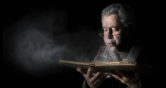 File:Man Blowing Dust Off Book.jpg